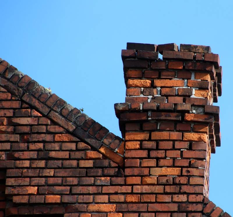 Damaged chimney on an Lake Arbor home showing cracks and missing mortar